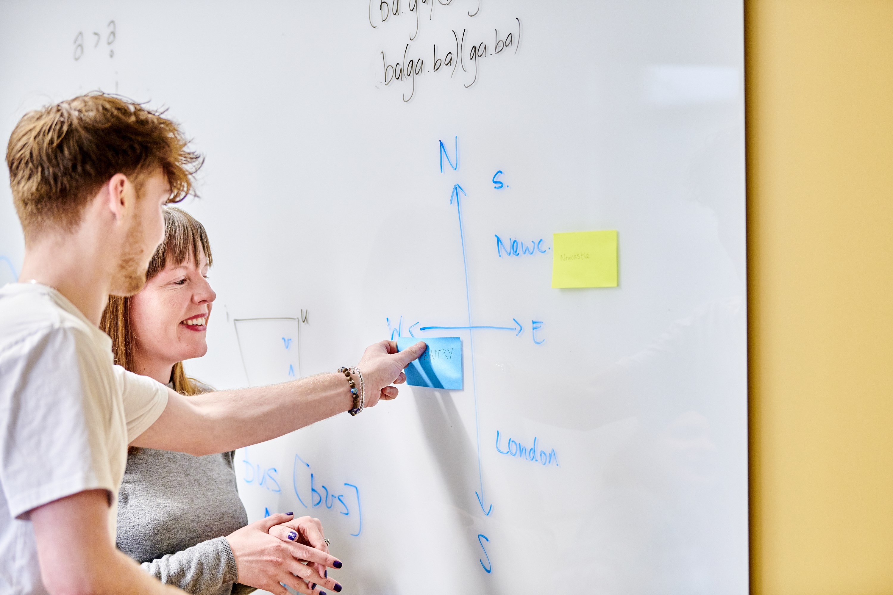 Student and teacher at a whiteboard